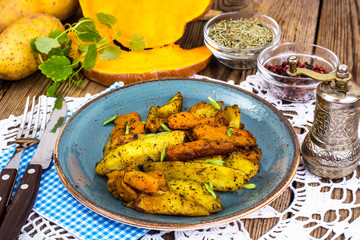 Baked vegetables, potatoes and pumpkin with herbs and spices