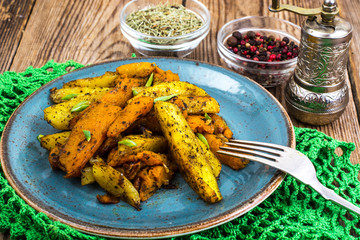 Baked vegetables, potatoes and pumpkin with herbs and spices