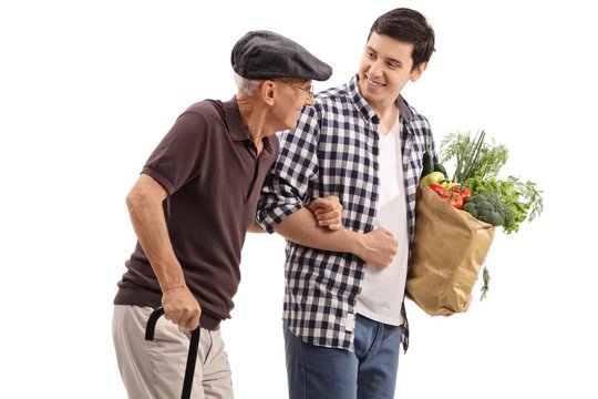 Young Guy Helping An Elderly Man With His Groceries