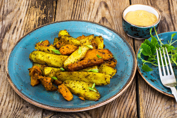 Baked vegetables, potatoes and pumpkin with herbs and spices