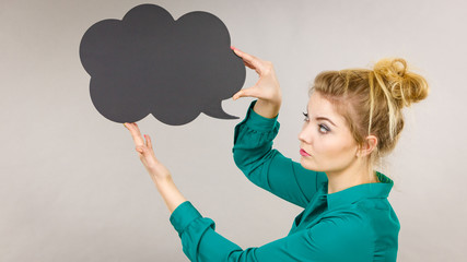 Woman holding black thinking bubble