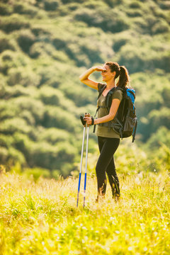 Young woman is hiking in mountain and enjoying nature. 
