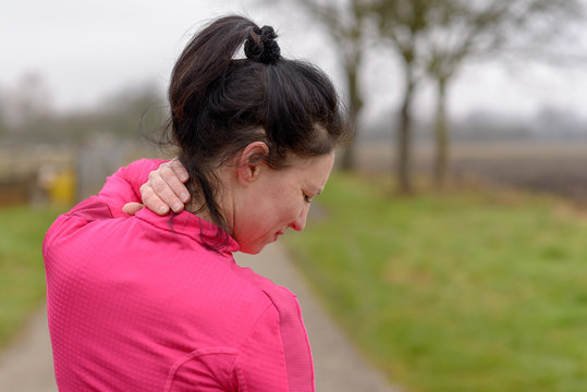 Woman clutching her neck in pain
