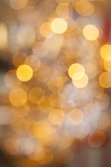 Golden glitter background with bokeh abstract blur effect