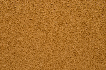 Orange textured wall. Orange colored textured blank wall.