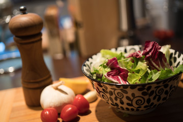 Fototapeta na wymiar Fresh salad with garlic, tomato, lemon on wooden board