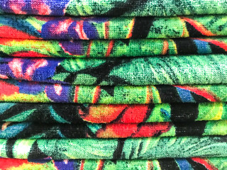 Stacks of colored terry towel on shelves