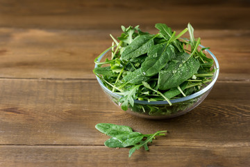 Bowl with Fresh Green Arugula  and Spinach on Wooden Background Mix with Spinach Rucola Copy Space Healthy Food