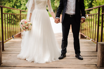 Fototapeta na wymiar Portrait of bride in a white dress and bridegroom in a wedding suit