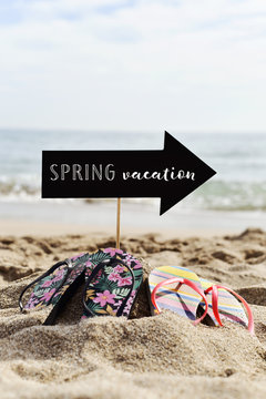 flip-flops on the beach and text spring vacation