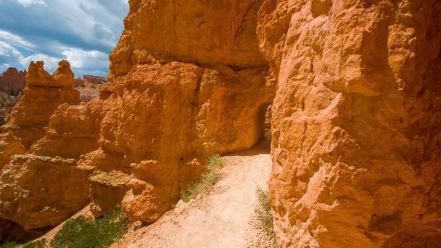 Video in motion along the trail. Walk along the path.Spectacular view at the yellow cliffs. Nature video. Amazing mountain landscape. Bryce Canyon National Park. Utah.USA. 4K, 3840*2160, high bit rate