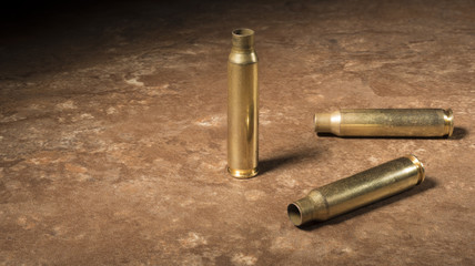 Three empty AR-15 rounds on the floor