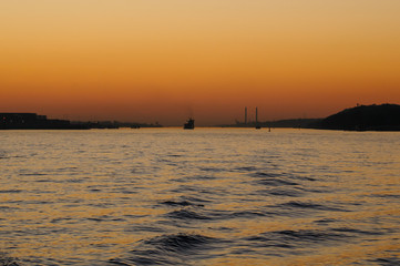 View from a Elbe ferry at sunset. Chimneys of power plant Wedel in the background.