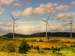 energy saving concept with wind turbine construction in field and meadow with beauty blue sky and...