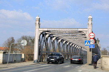 Zabytkowy most nitowany w Brzegu nad rzeką Odrą, samochody, ludzie. - obrazy, fototapety, plakaty