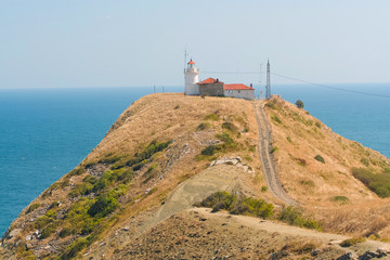 Fototapeta na wymiar Old lighthouse on the seashore in Bulgaria, beautiful coast landscape.