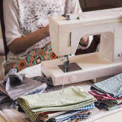 Girl working on sewing machine with textile napkins