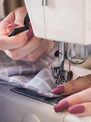 Girl working on sewing machine with textile napkins