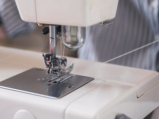 Girl working on sewing machine with textile napkins