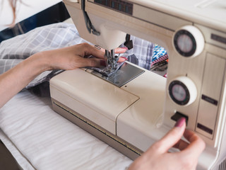 Girl working on sewing machine with textile napkins