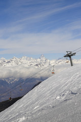 Panoramic view of wide and groomed ski piste in resort of Pila in Valle d'Aosta, Italy during winter