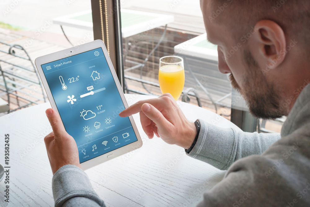 Poster smart home control app on laptop display in man hands.