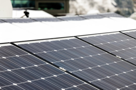 Photovoltaic panels on the roof cover with snow, in the winter