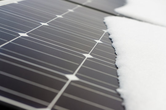 Photovoltaic panels on the roof cover with snow, in the winter