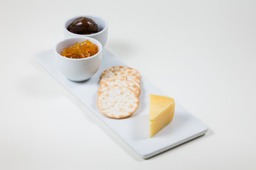Cheese and Crackers on a white plate on a white background isolated