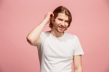 Obraz premium The happy business man standing and smiling against pink background.