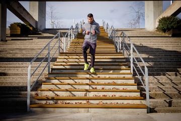 Young athlete man runs up and down the stairs