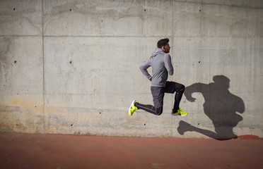 Young athlete man jumping in the park