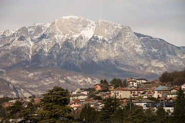 Fototapeta na wymiar Alpine town village Povo Trento in winter light rural italian houses