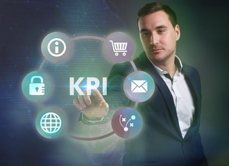 Business, Technology, Internet and network concept. Young businessman working on a virtual screen of the future and sees the inscription: KPI