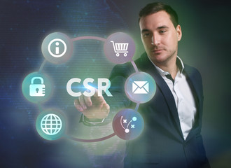 Business, Technology, Internet and network concept. Young businessman working on a virtual screen of the future and sees the inscription: CSR