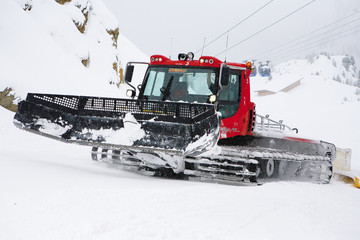 Snow plow in mountain ski resort