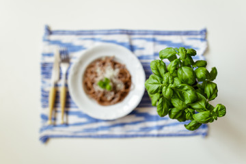 Basil against a plate of wholemeal spaghetti