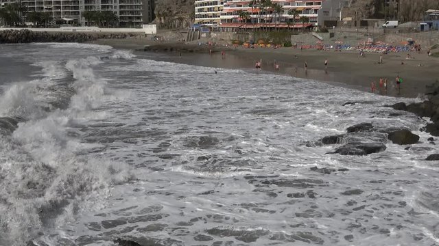 Arguineguin Gran Canaria Spain: Tourists swimming in the sea on Patacalva beach