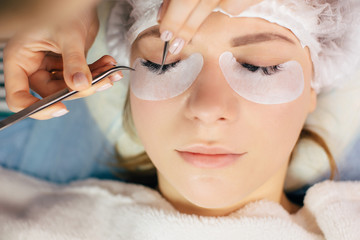 Eyelash Extension Procedure. Woman Eye with Long Eyelashes. Lashes, close up, selected focus.