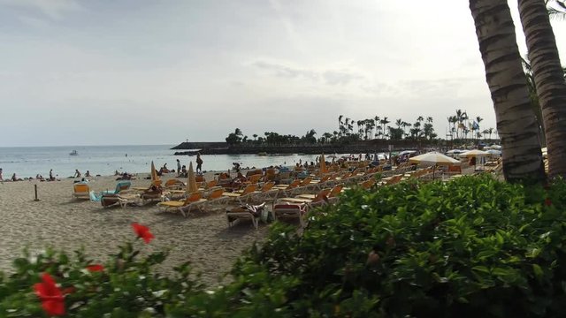 Anfi Gran Canaria Spain: Tourists walking next to the Anfi del Mar beach