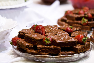 Stack of Brownies With Strawberries Plated for a Party