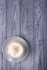 Coffee cappuccino with ceylon cinnamon on a gray background. Top view. Free space