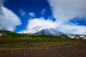 Fototapeta premium Mountain landscape: view on active Koryaksky Volcano on a sunny day. Koryaksky-Avachinsky Group of Volcanoes, Kamchatka Peninsula, Russia, Far East