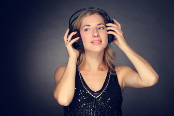 young girl listening to music on headphones
