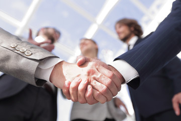 in the foreground.handshake of business partners