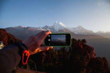 A man hands holding mobile take photo holding smartphone taking photo at mountain view. - 193597234