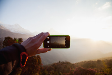 A man hands holding mobile take photo holding smartphone taking photo at mountain view. - 193597256