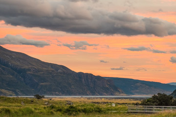 High ISO shot, Beautiful scene at sunset in Mt Cook National Park with orange and yellow sky with Cloudy