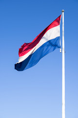 Fototapeta na wymiar Dutch flag flying in the wind