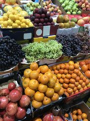 Various fruits on market counter.